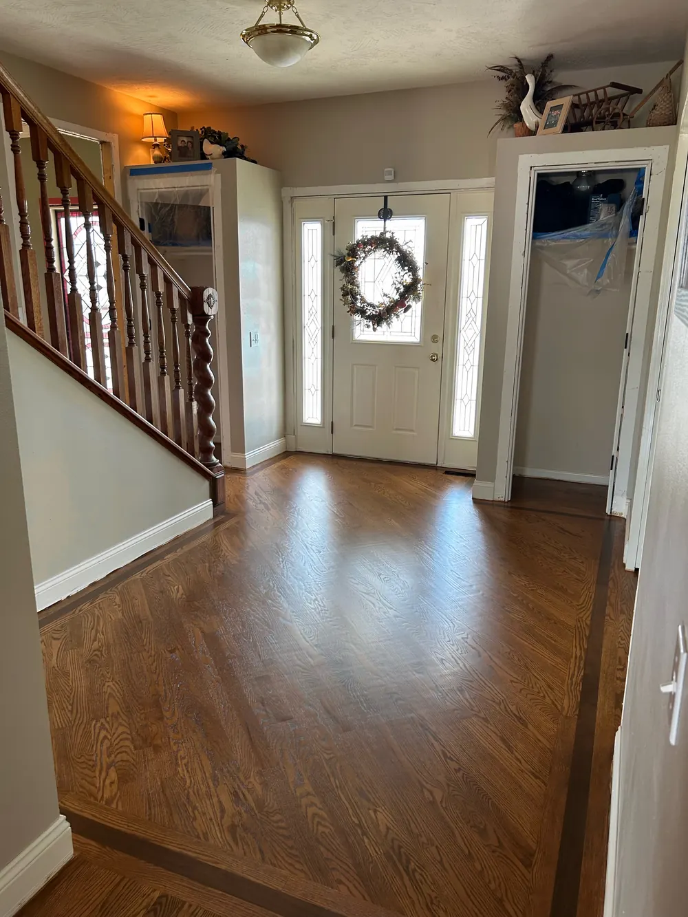 Entry hall in stained oak framed by a dark border inlay