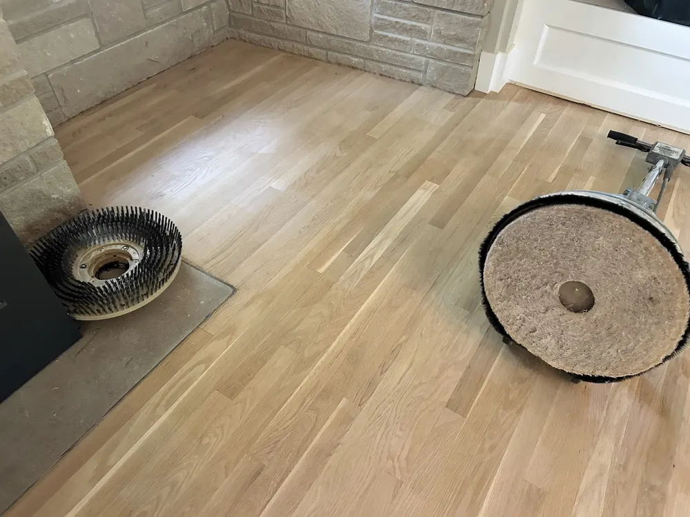 Freshly sanded white oak fitted tight against a stone hearth