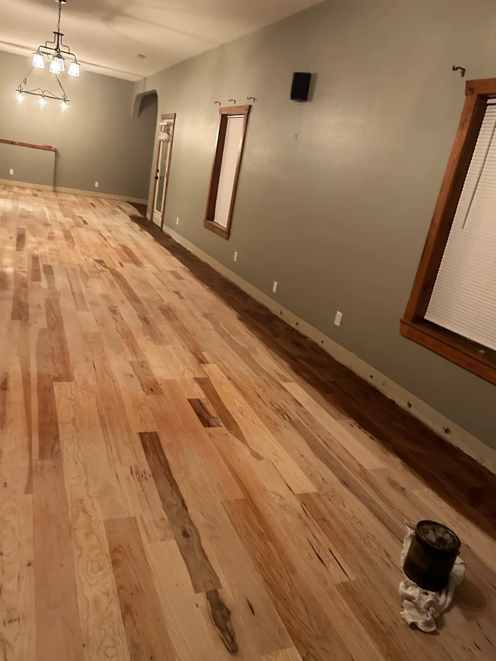 A rustic hickory floor sanded to bare wood, showing strong light and dark color variation